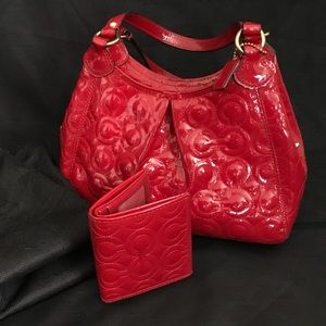 Coach patent red handbag with matching wallet.